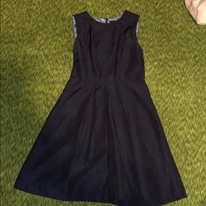Navy sleeveless dress with flared pleated skirt